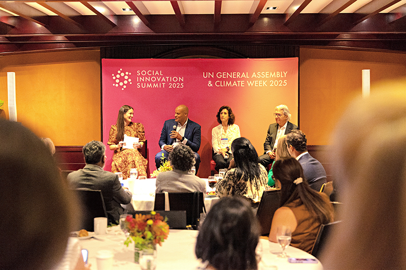Four speakers participate in a Social Innovation Summit 2025 panel during UN Climate Week, discussing nonprofit board leadership before a seated audience.
