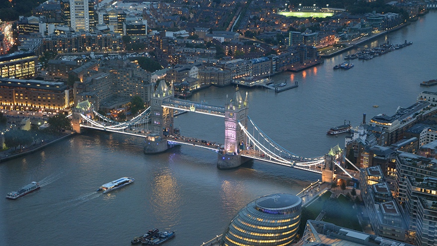 Tower Bridge night view highlights Apollo’s London office and global reach in asset management and private equity.
