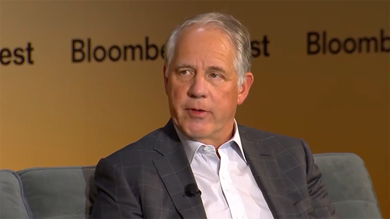 Jim Zelter wears a suit and sits in front of a Bloomberg-branded backdrop during Bloomberg Invest to discuss private credit and investment-grade capital solutions.