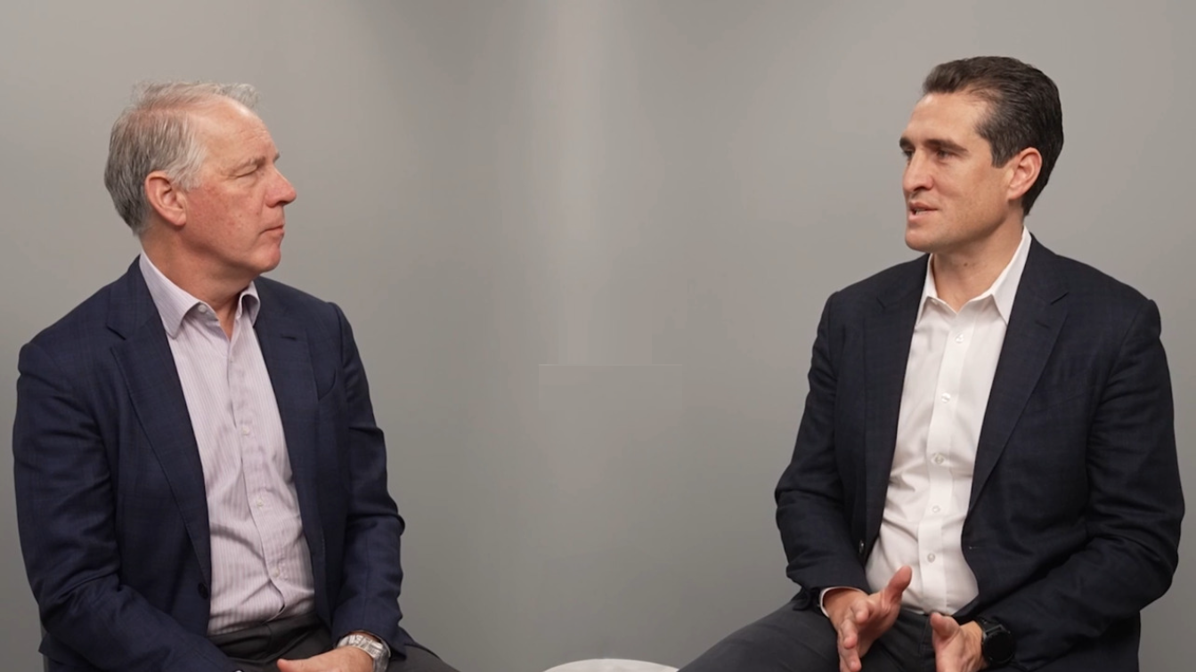 Marc Rowan, Apollo CEO, is seated on stage in a dark suit and white shirt, speaking into a headset mic at the 2025 Bloomberg New Economy Forum in Singapore, with a teal background displaying the event’s logo.