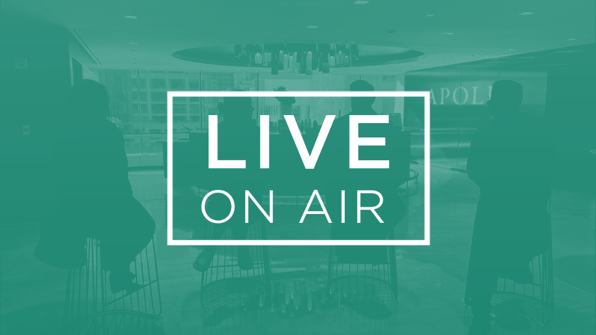 Silhouetted panelists seated in Apollo’s office lobby during a live broadcast, with the words "LIVE ON AIR" displayed prominently over the scene.